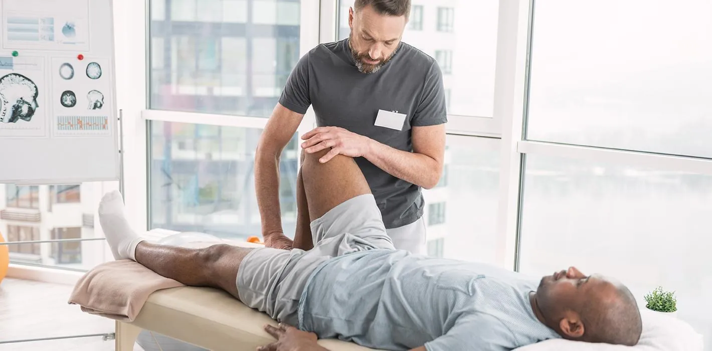 Clinician fitting a knee brace for a patient at RegenLife